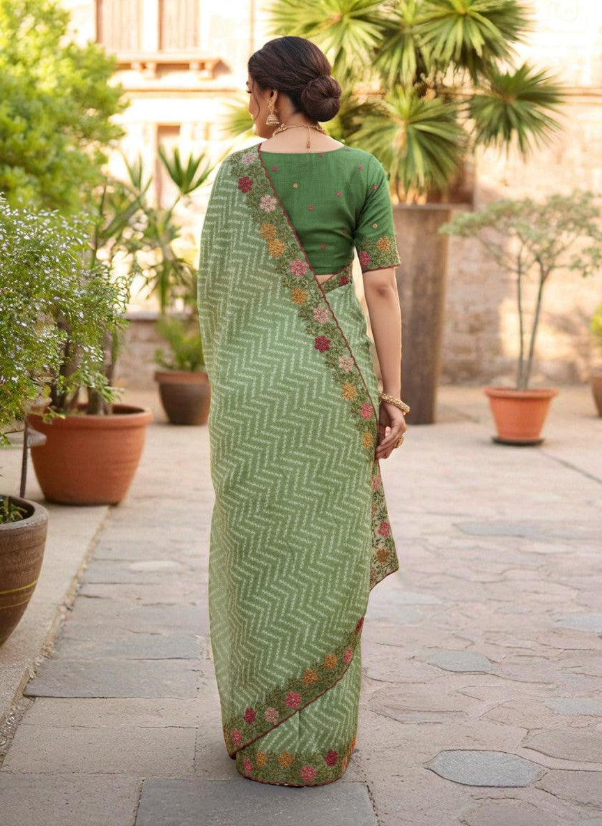 Woman wearing a saree with floral patterns green