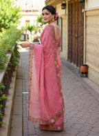 Woman wearing a saree with floral patterns pink