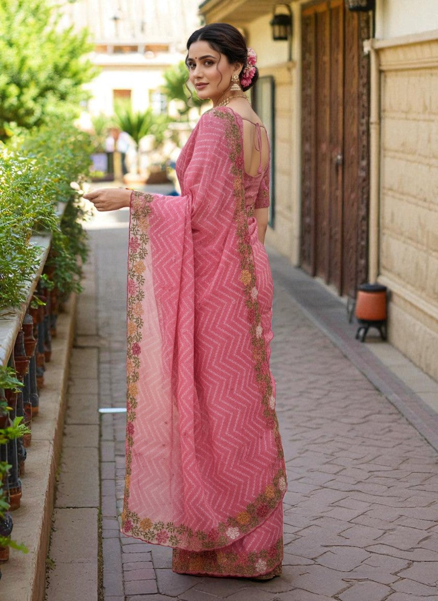 Woman wearing a saree with floral patterns pink