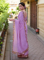 Woman wearing a saree with floral patterns purple