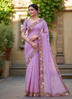 Woman wearing a saree with floral patterns purple