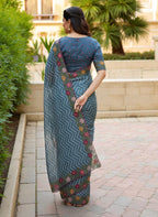 Woman wearing a saree with floral patterns rama