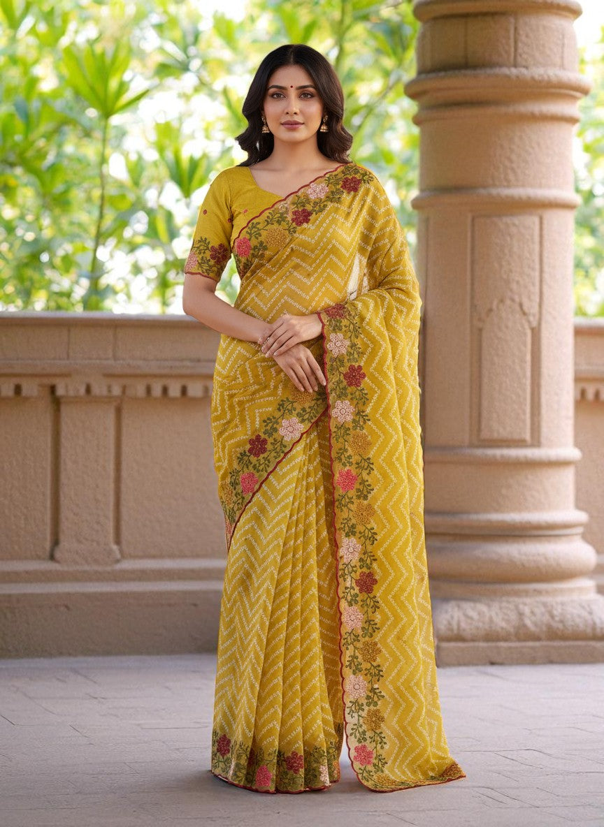 Woman wearing a yellow saree with floral patterns yellow